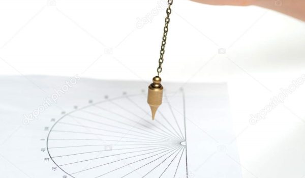 Arm of dowser with hand-held pendulum over the chart. Selective focus.